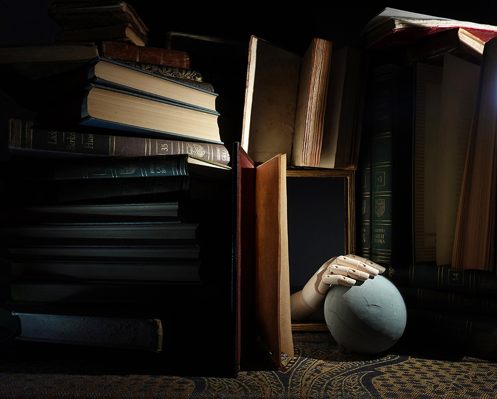 surrealism, dream, library, books, bookshelf, hand, haunted, ball, sphere, wooden hand, articulated hand, surreal library